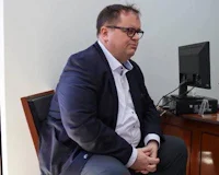 Fat consul Thomas WAgner sits on a chair and looks worried